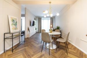a living room with a dining room table and chairs at AH Luxury Designer Aparment Bastova in Košice