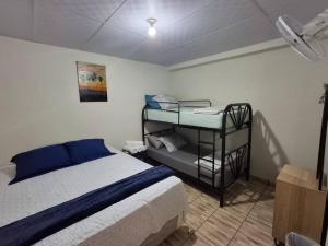 a bedroom with a bed and a shelf with towels at Casa Centro Histórico Santa Ana in Santa Ana