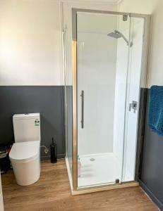 a shower stall in a bathroom with a toilet at Hennessy Beach House in Port Campbell +23 photos