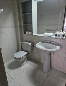 a bathroom with a toilet and a sink at Hotel 5 Norte in Viña del Mar