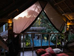 a room with a view of a swimming pool through a window at La Bohème Boutique Glamping in General Luna +59 photos