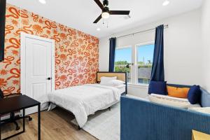a bedroom with a bed and a couch and a window at Downtown Luxe Retreat - King Bed, Pool, Pong, Billiards, Grill & FREE Coffee in Houston