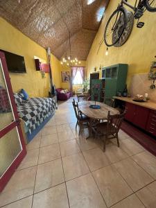 a living room with a table and a bike on the ceiling at Casa Mestre in Vila do Bispo