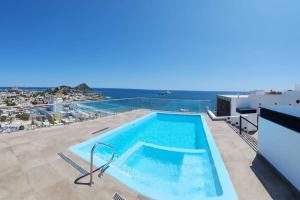 a large swimming pool on the roof of a building at Stunning Oceanview apartment in Mazatlan in Mazatlán