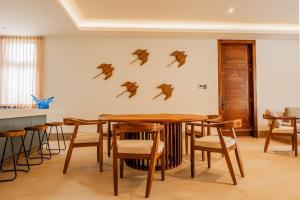 a dining room with a table and chairs at Tropical Oasis with cook and Housekeeping service INCLUDED Private Pool BBQ Beach Access in Cruz de Huanacaxtle