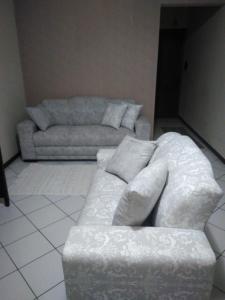 a living room with a couch and a couch and a chair at Apartamento Oktotoberfest Blumenau DAL in Blumenau