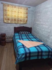 Postel nebo postele na pokoji v ubytování Hostal La Rosita