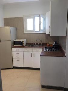 a kitchen with a white refrigerator and a sink at Tallinn Travel in Sharm El Sheikh