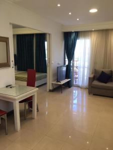 a living room with a couch and a table and a television at Tallinn Travel in Sharm El Sheikh