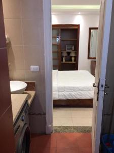 a bathroom with a bedroom with a bed and a sink at Tallinn Travel in Sharm El Sheikh