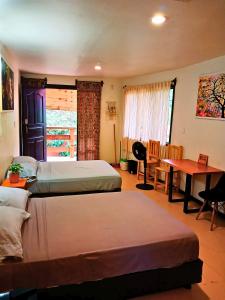Una cama o camas en una habitación de Casa NAU Mazunte