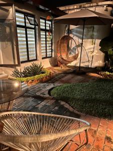 un patio con banco y sombrilla en Villa de Los Ángeles, en Antigua Guatemala
