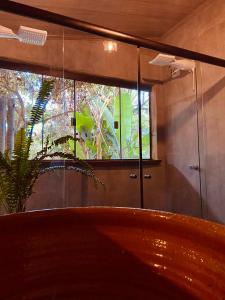 a room with a large window and a wooden bench at Casa Lobo-guará in Alto Paraíso de Goiás +39 photos