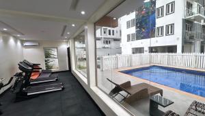 a living room with a swimming pool and a house at Luxury Two Bedroom Apartment Victoria Island in Lagos