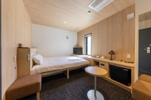 Letto o letti in una camera di WeBase Hiroshima