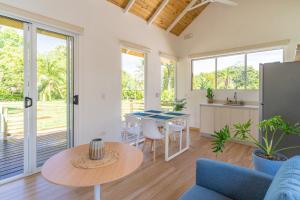 a living room with a table and a kitchen at Cedrela Beach Villas in Uvita