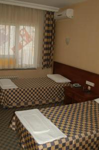 Postel nebo postele na pokoji v ubytování Saray Hotel