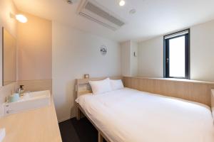 Letto o letti in una camera di WeBase Hiroshima