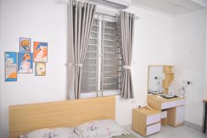 a bedroom with a window and a bed and a desk at Tuyên Quang 301TK27 in Hanoi