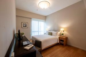 Ein Bett oder Betten in einem Zimmer der Unterkunft Lanson Place Bukit Ceylon