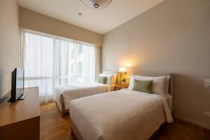 Ein Bett oder Betten in einem Zimmer der Unterkunft Lanson Place Bukit Ceylon