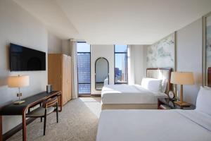 a hotel room with two beds and a television at Hotel Ivy, a Luxury Collection Hotel, Minneapolis in Minneapolis +155 photos