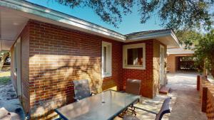 a brick house with a table and chairs at ALWAYS TURTLE CRAWL home in Jekyll Island
