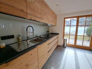 a kitchen with a sink and a counter top at Ferienhaus Hirschwiesn -565- in Krün