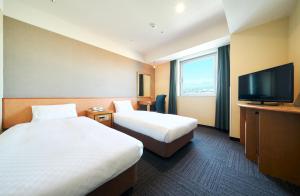 Postel nebo postele na pokoji v ubytování Kanku Izumiotsu Washington Hotel + 23 fotografií