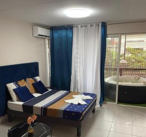 a bedroom with a bed and a bath tub at Pacifique Suite in Cayenne