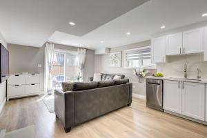 a living room with a couch and a kitchen at New Furnished 1bedroom basement in Waterloo