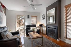 a living room with a couch and a fireplace at Villa Sorelle in the heart of Daylesford in Daylesford