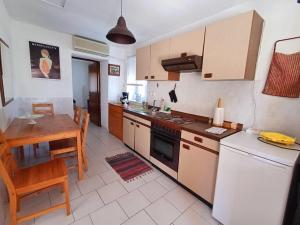 a kitchen with a table and a counter top at Grandma's House Aliki Thassos in Alyki