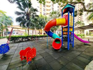 a playground in a park with a slide at Affordable Stay Near Tropicana Thomson Hospital Kota Damansara SEGI Giza Mall Tropicana Mall Ikea The Curve One Utama ML in Petaling Jaya