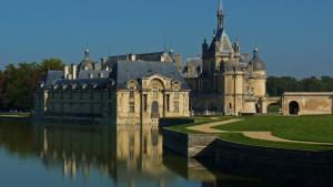 a large castle sitting on top of a body of water at Relais De La Haute Pommeraye in Apremont +13 photos