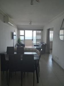 a living room with a table and chairs and a couch at Blue Largo Sea View in Westbrook