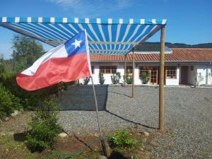 una bandera en un poste delante de una casa en La Maravilla Lodge, en Vilches