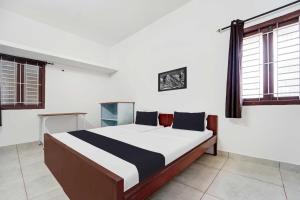 Ένα ή περισσότερα κρεβάτια σε δωμάτιο στο Hotel O Kayilai Homestays