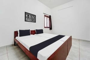 Ένα ή περισσότερα κρεβάτια σε δωμάτιο στο Hotel O Kayilai Homestays +25 φωτογραφίες