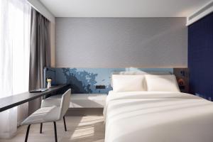 Cama o camas de una habitación en Atour Light Hotel Shenyang Yuhong Plaza Metro Station