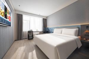 Cama o camas de una habitación en Atour Light Hotel Shenyang Yuhong Plaza Metro Station