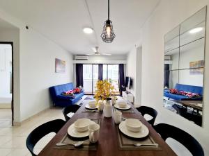 a dining room with a long wooden table and chairs at Affordable Stay Near Tropicana Thomson Hospital Kota Damansara SEGI Giza Mall Tropicana Mall Ikea The Curve One Utama ML in Petaling Jaya