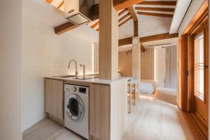 a kitchen with a washer and dryer in a house at Luxury Hanok Cottage Lunar in Seoul