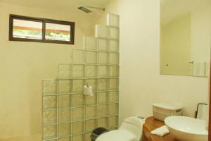 a bathroom with a toilet and a sink at Casa Manzanillo Surf in Boca de Ario +31 photos