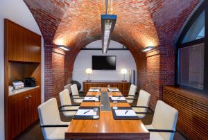 a conference room with a long table and chairs at MÖVENPICK Hotel Hamburg City in Hamburg +207 photos