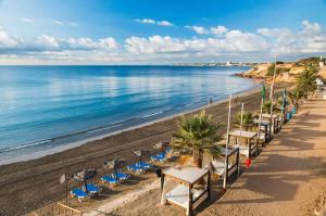 a row of tables and chairs on a beach at El mirador de Santa Justa in Orihuela