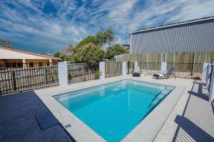 a swimming pool in a yard with a fence at Aquatic Abode in Agnes Water