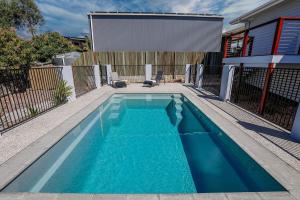 a swimming pool in the backyard of a house at Aquatic Abode in Agnes Water
