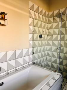 a bathroom with a tub and a shower at Luxury Stay With Affordable Price in Johannesburg
