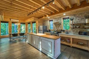 a large kitchen with wooden walls and wooden floors at Alta Maya in Gatlinburg